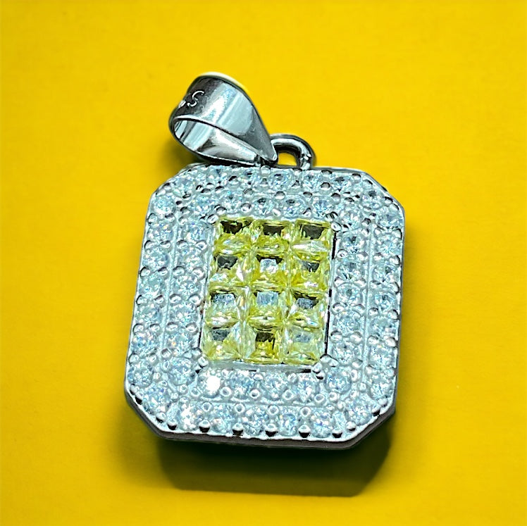 a yellow and white diamond pendant on a yellow background