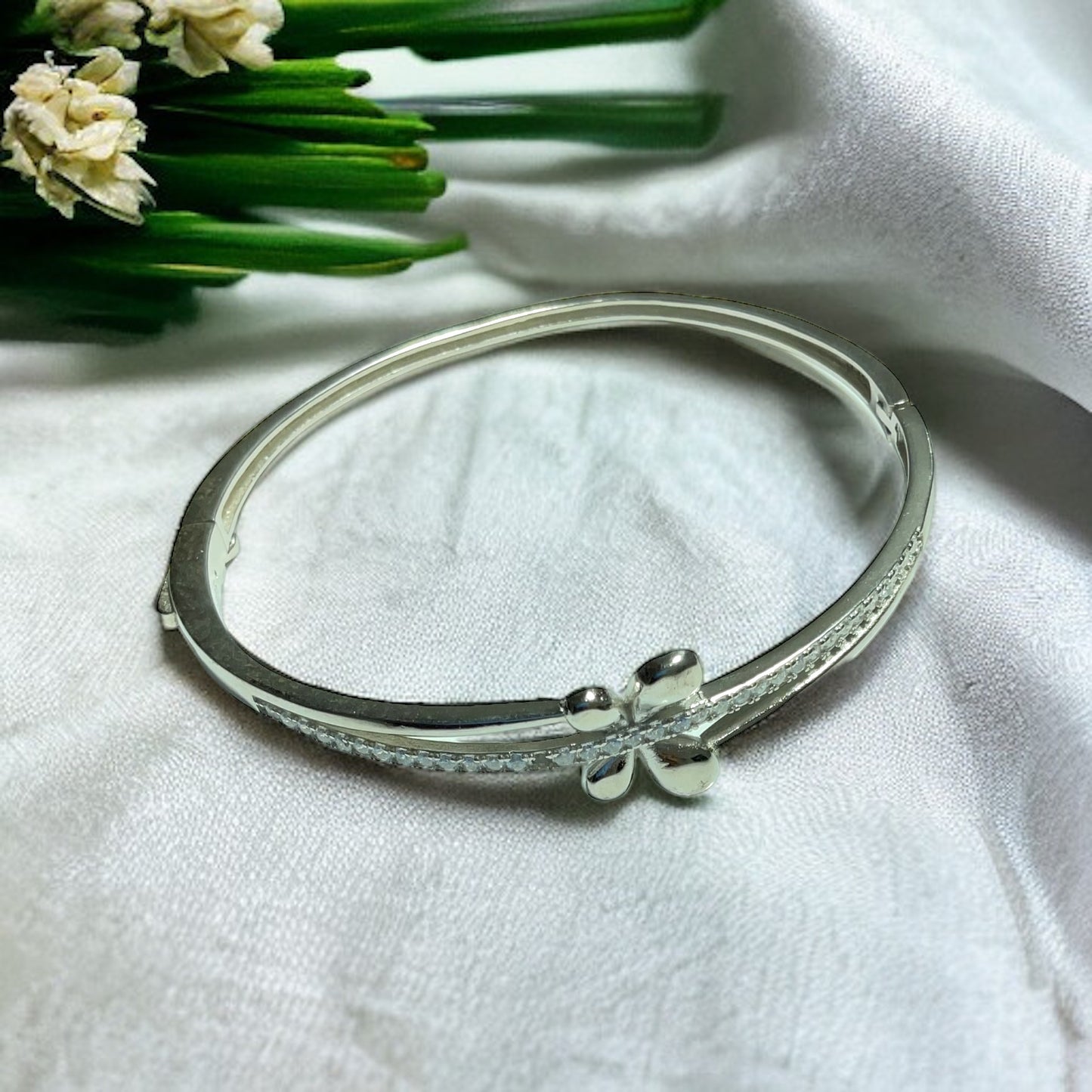 a close up of a bracelet on a white cloth