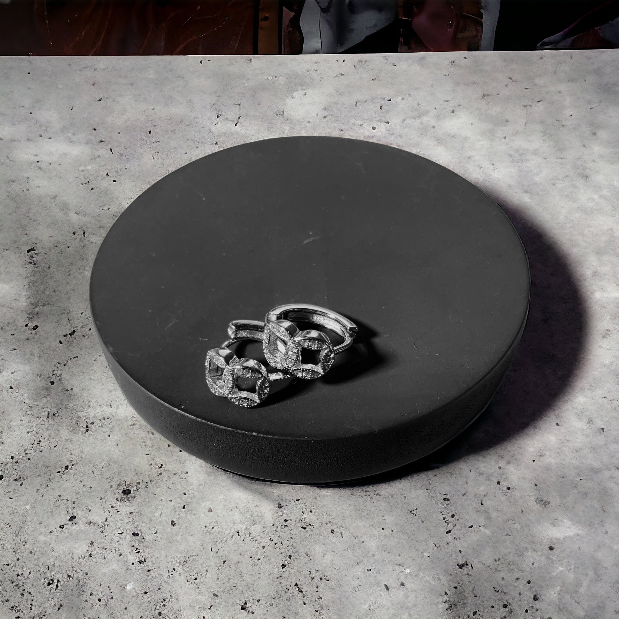 a couple of rings sitting on top of a black box