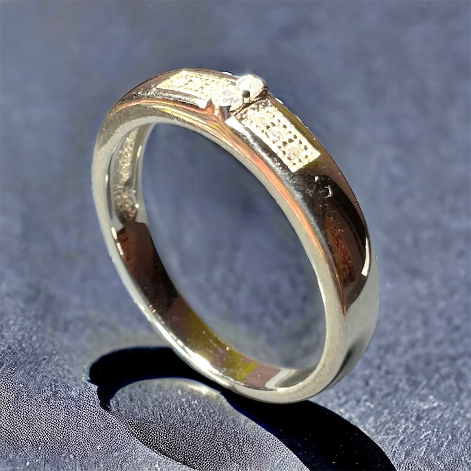 a close up of a wedding ring on a table