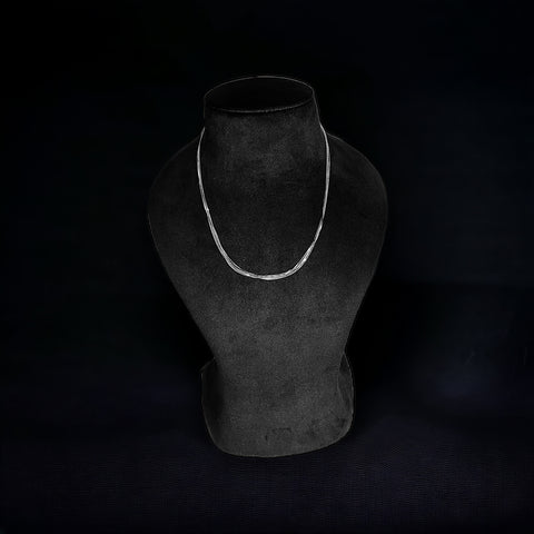 a black mannequin with a white necklace on it