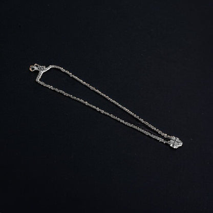 a silver chain with a cross on it