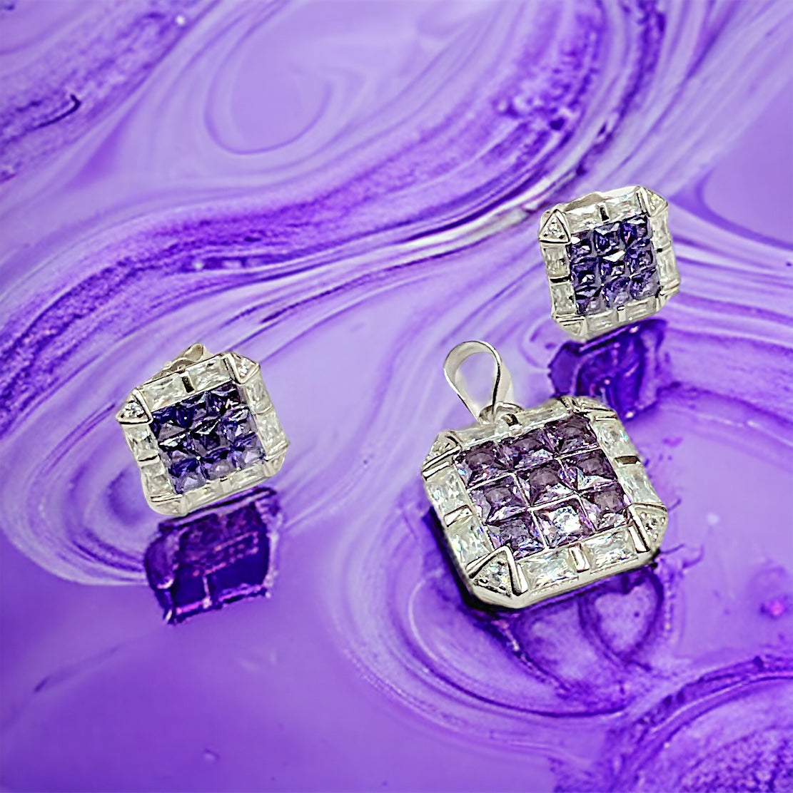 a pair of purple and white diamond earrings
