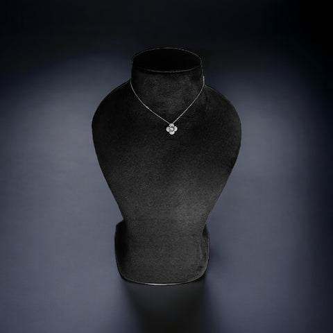 a black vase with a necklace on it