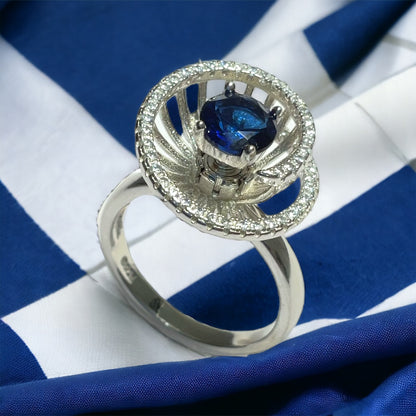 a blue and white diamond ring on a blue and white striped cloth