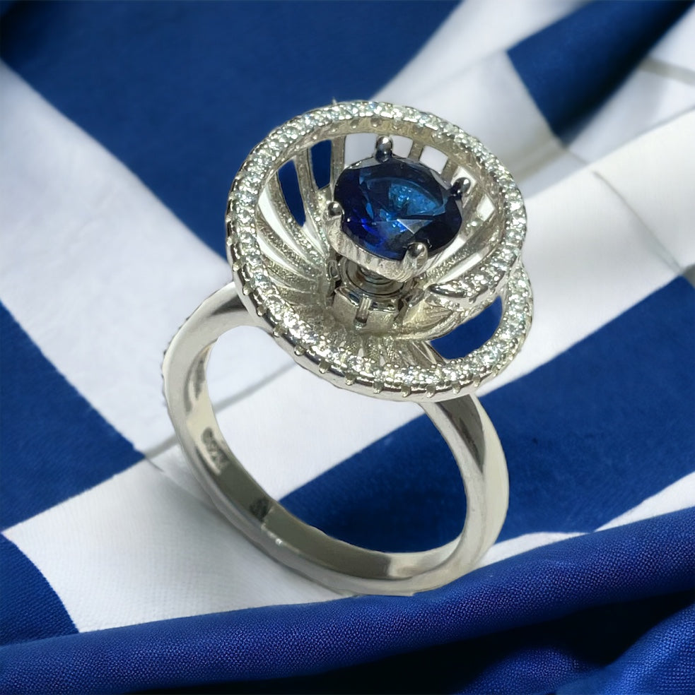 a blue and white diamond ring on a blue and white striped cloth