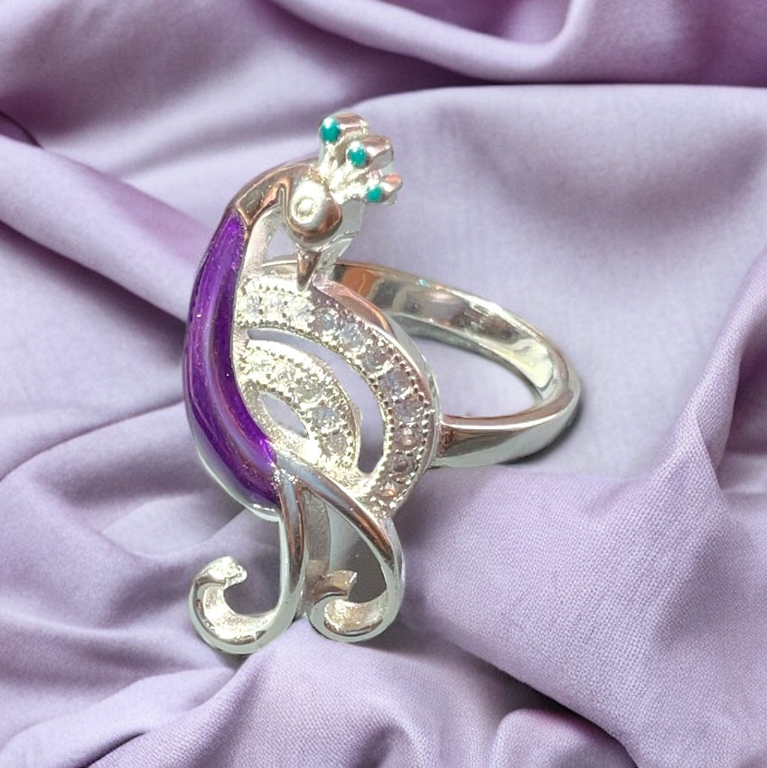 a close up of a ring on a purple cloth