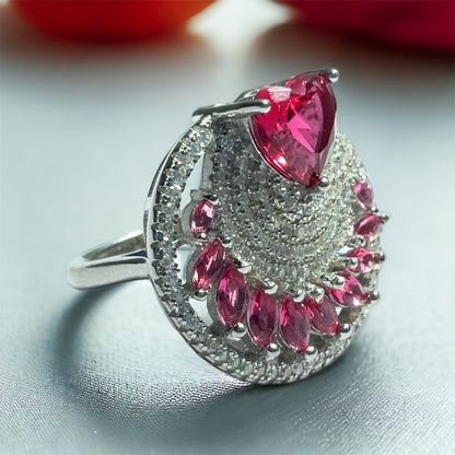 a ring with a large pink stone surrounded by smaller pink stones