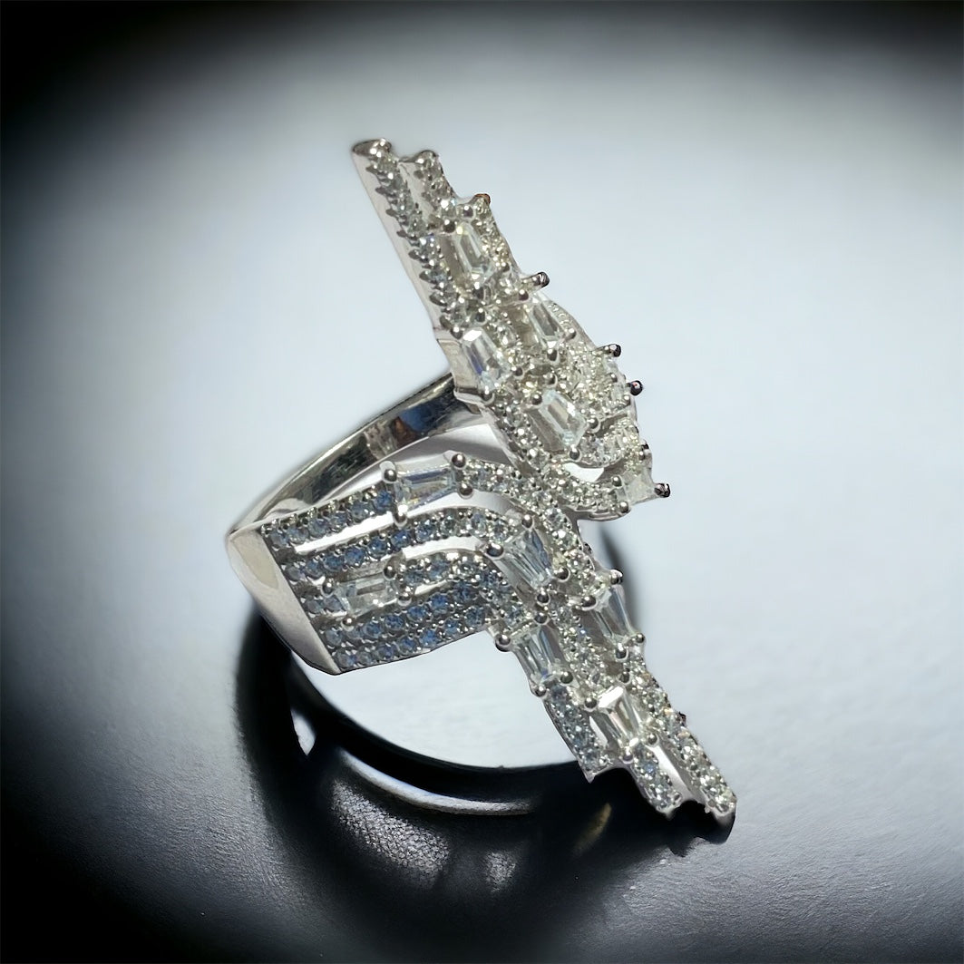 a diamond ring on a table with a white background