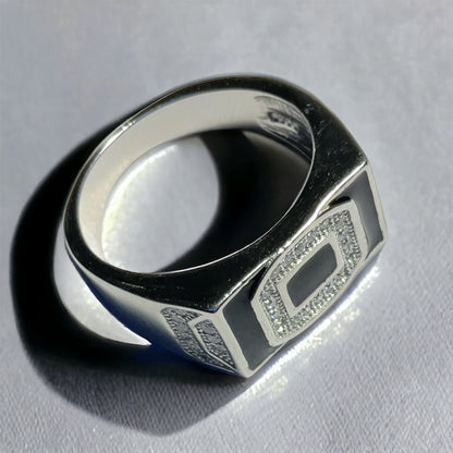 a black and white ring on a white surface