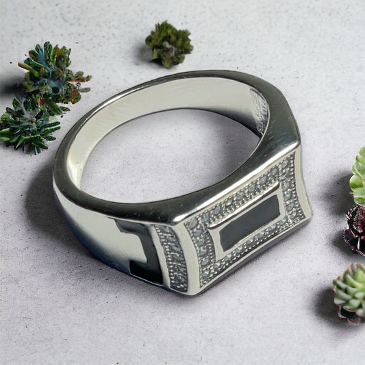 a ring sitting on top of a table next to small plants