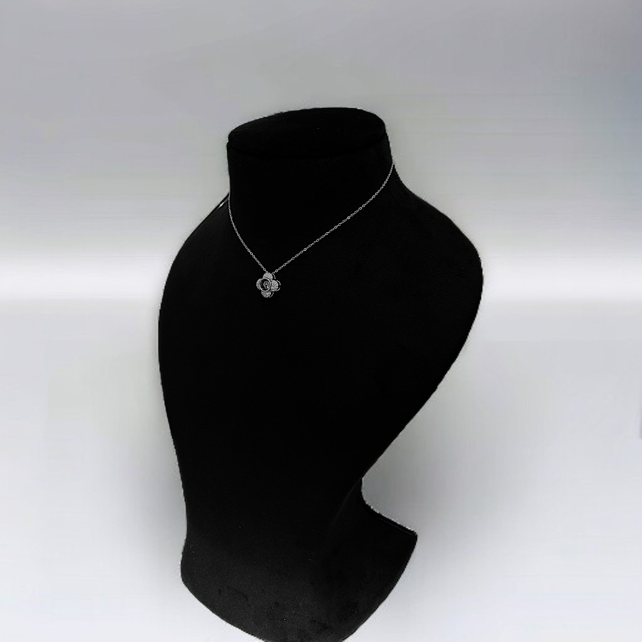 a black mannequin with a necklace on it