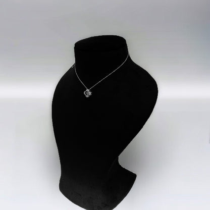 a black mannequin with a necklace on it