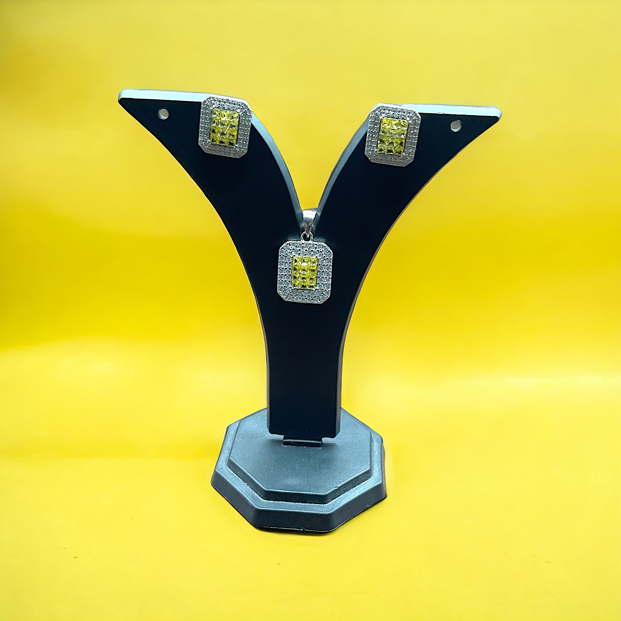 a black and silver object with a yellow background