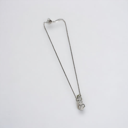 a silver necklace with a heart on it