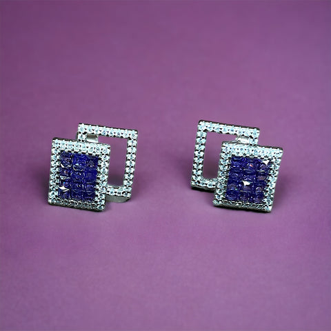 a pair of square shaped blue and white diamond earrings