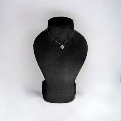 a black and white photo of a necklace on a mannequin