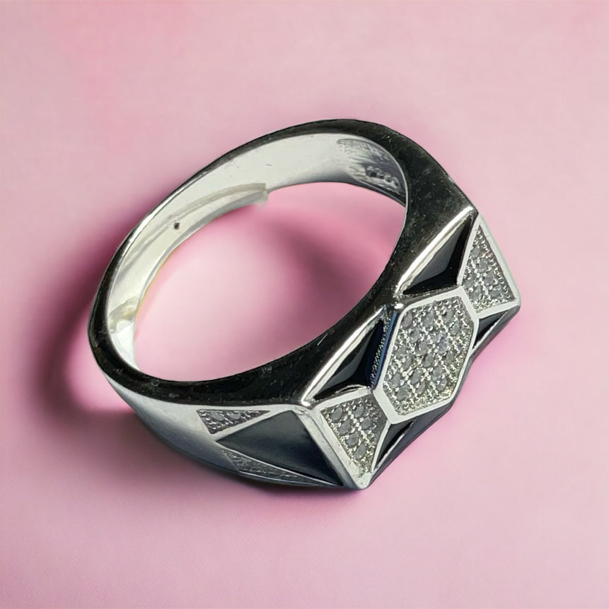 a black and white ring on a pink background