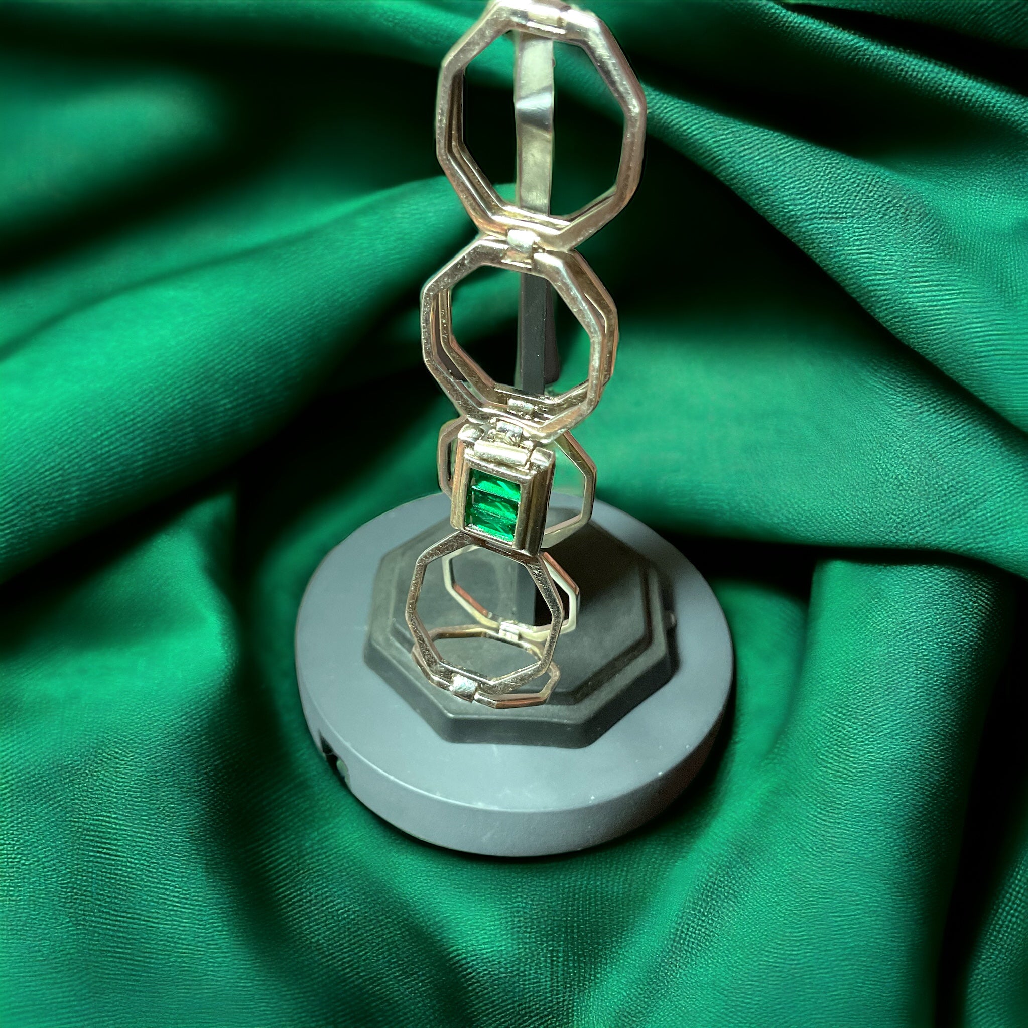 a metal object sitting on top of a green cloth