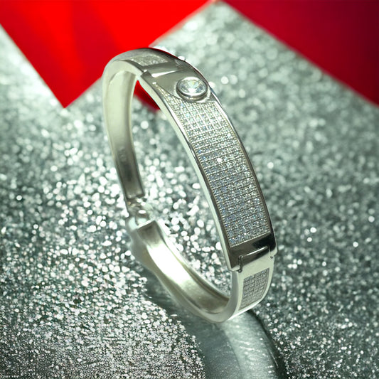 a close up of a silver bracelet on a table