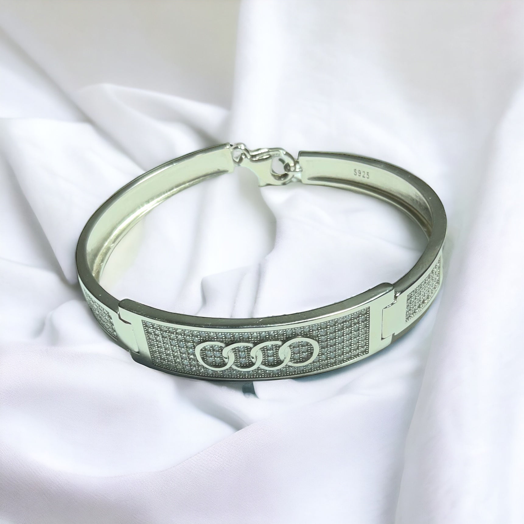 a close up of a bracelet on a white cloth