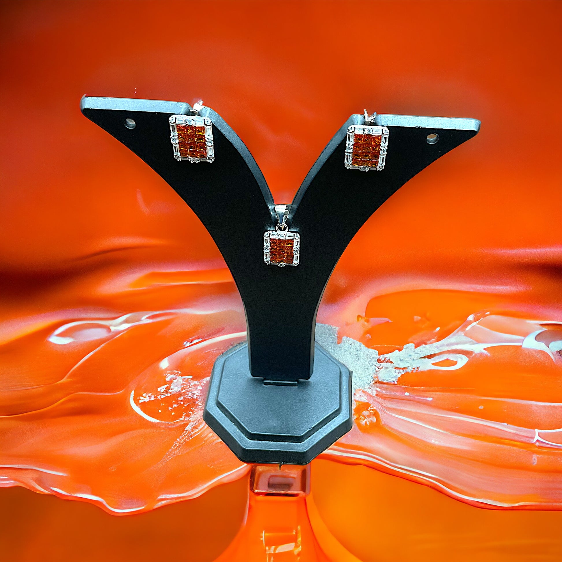 a close up of a pair of earrings on an orange background