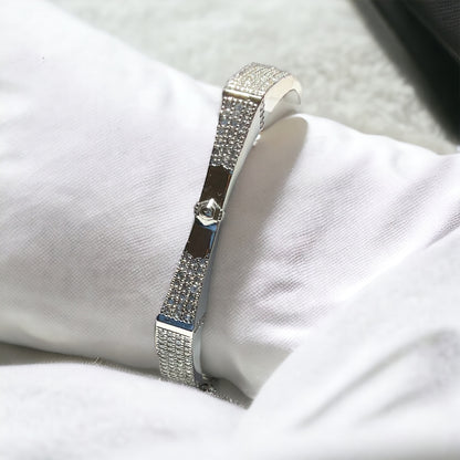 a diamond bracelet sitting on top of a white pillow