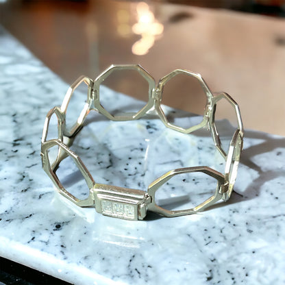 a close up of a bracelet on a table