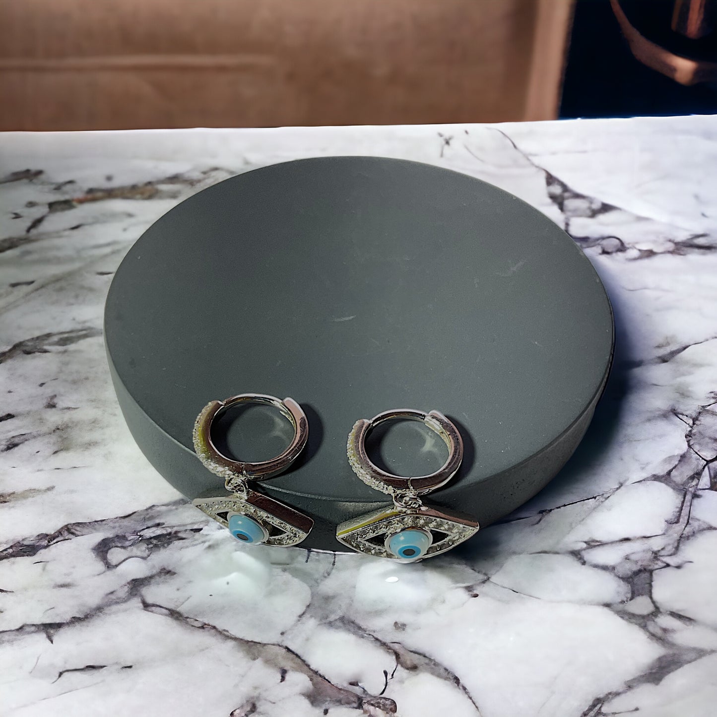 a pair of earrings sitting on top of a table