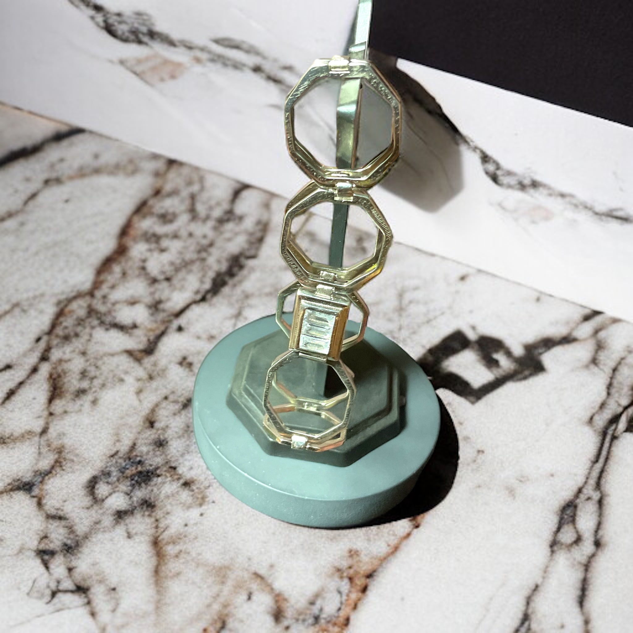 a glass sculpture sitting on top of a marble counter