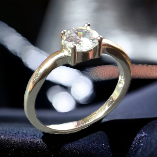 a close up of a ring with a diamond on it