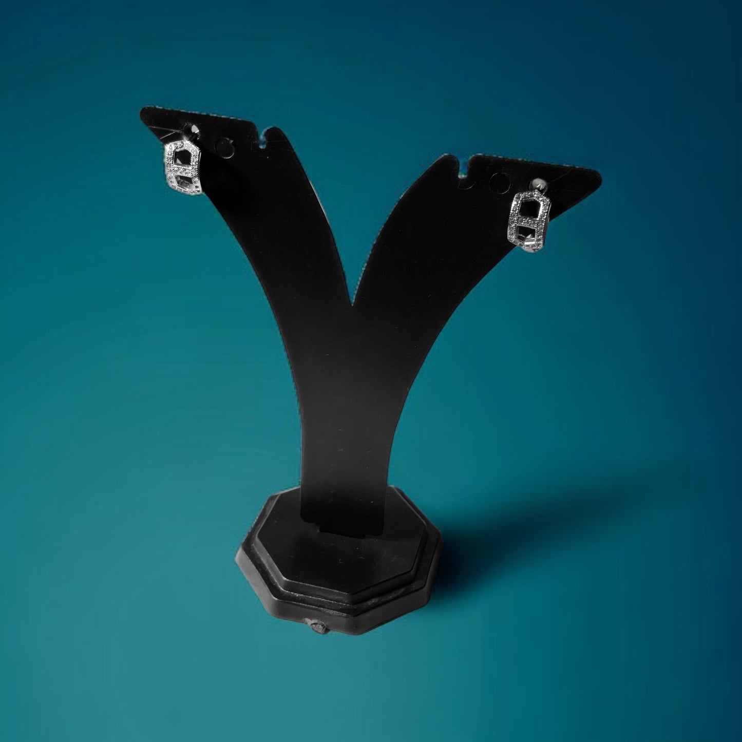 a pair of black metal brackets on a blue background