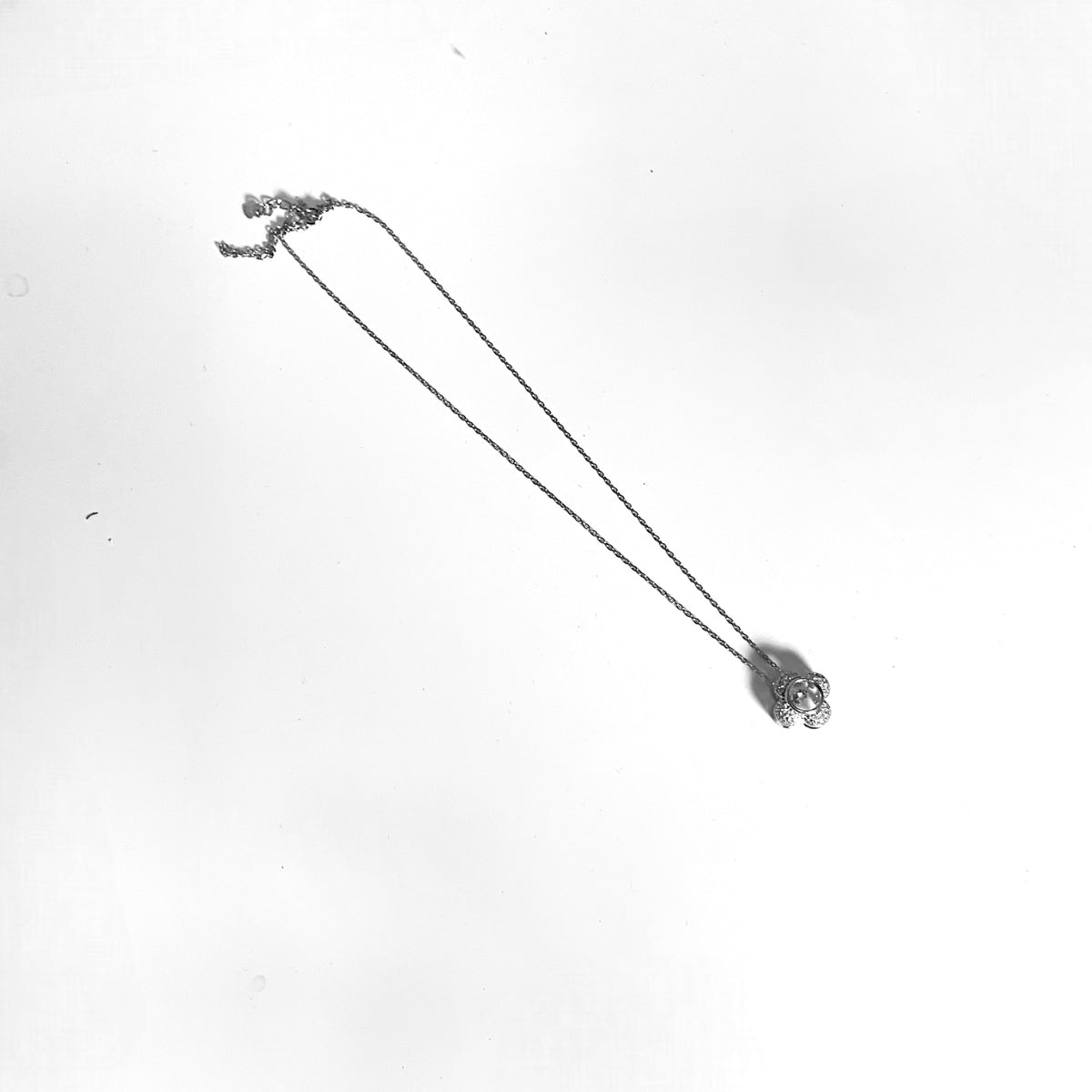 a black and white photo of a flower in the air