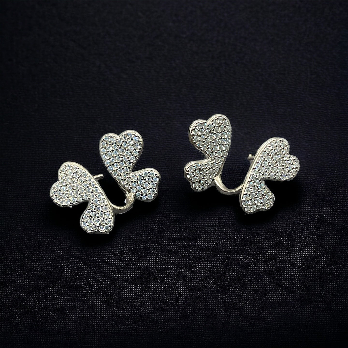 a pair of earrings with hearts on them