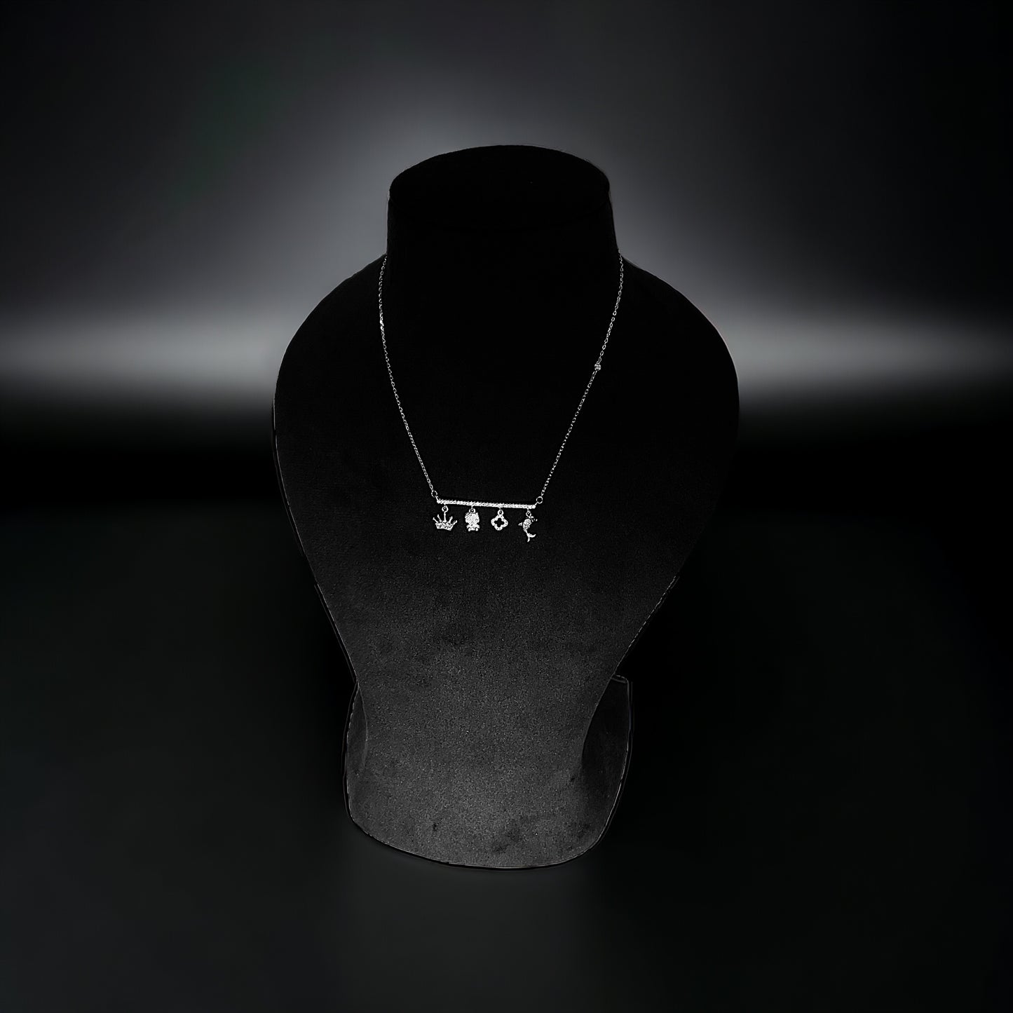 a necklace on a mannequin with a black background