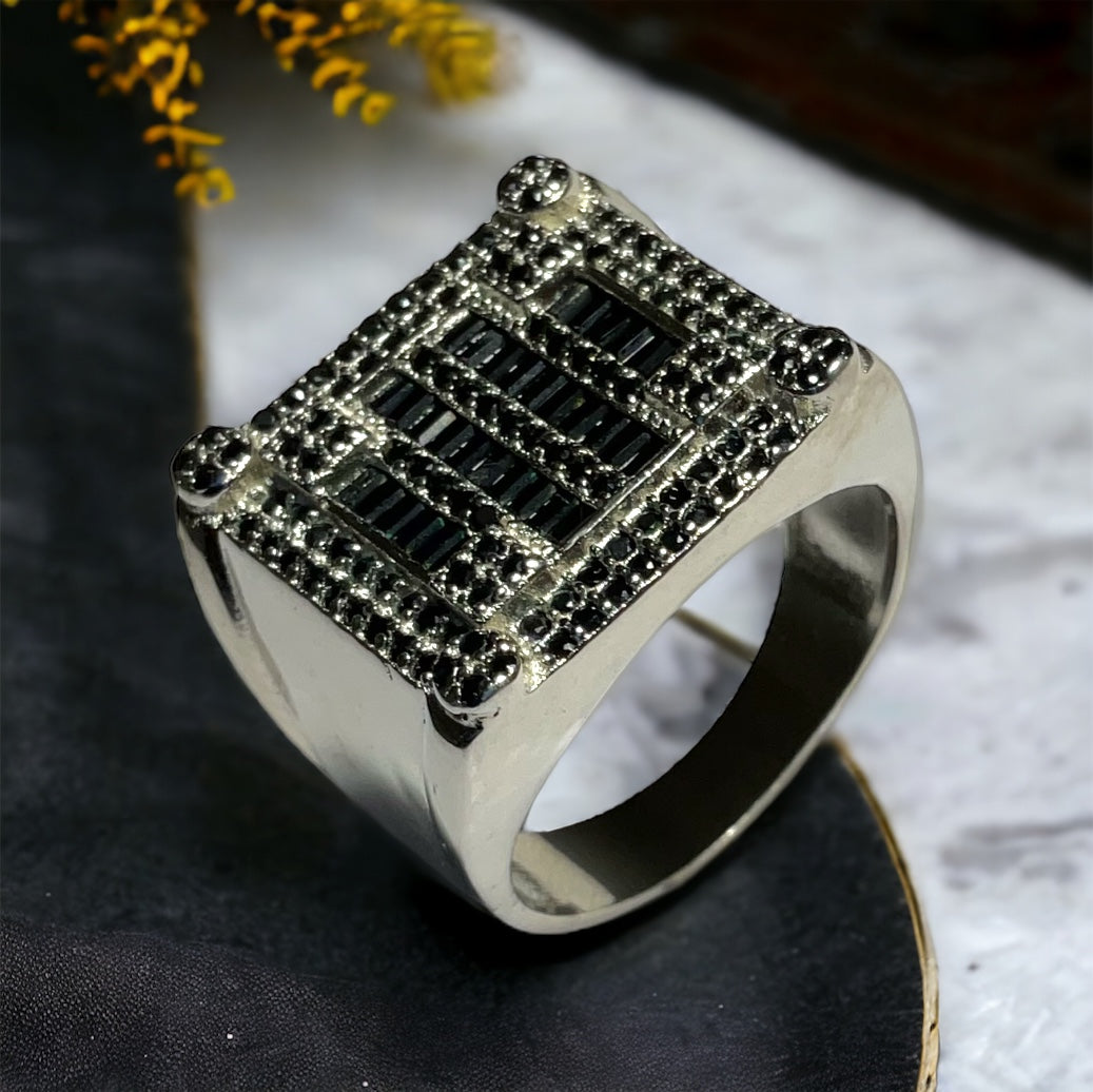 a silver ring with black and white diamonds
