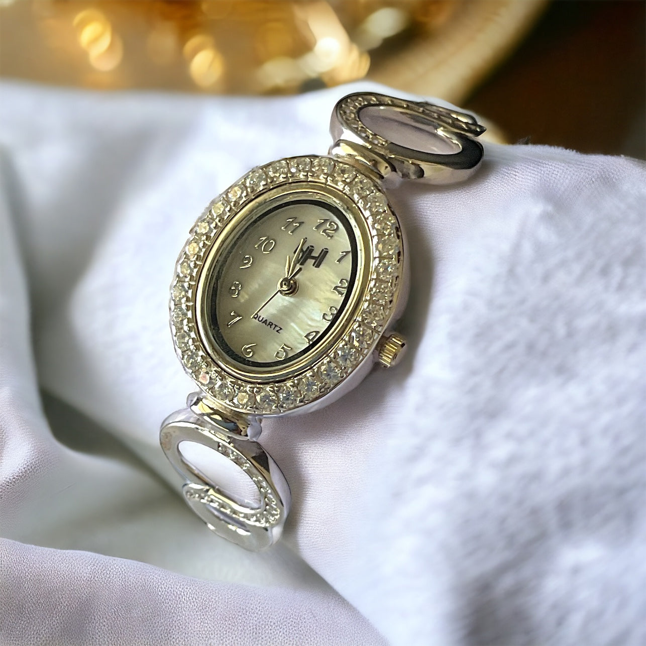 a close up of a watch on a napkin