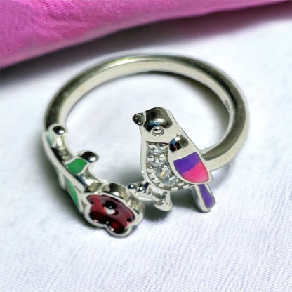 a close up of a ring with a bird on it