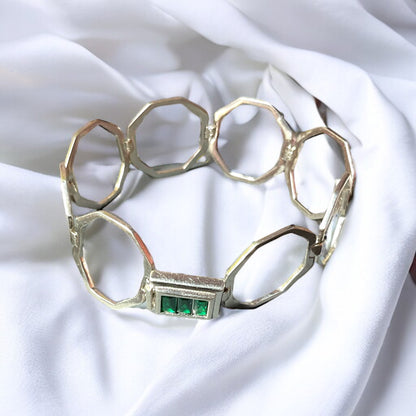 a close up of a bracelet on a white cloth