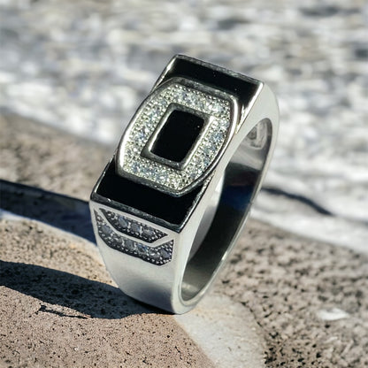 a silver ring with a black stone in the center