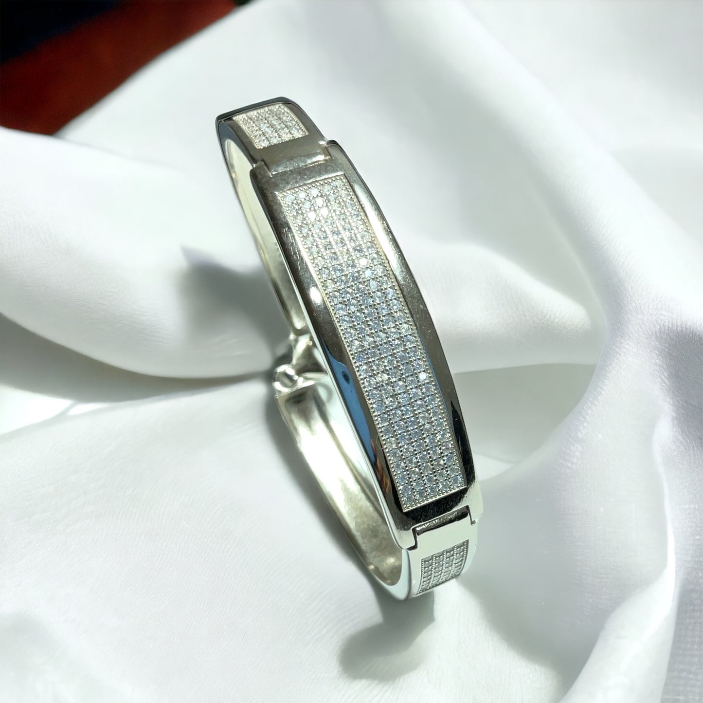 a white gold and diamond ring on a white cloth