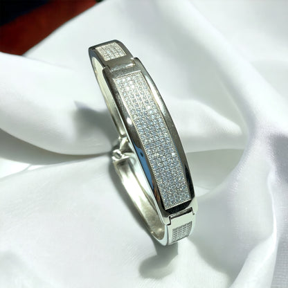 a white gold and diamond ring on a white cloth