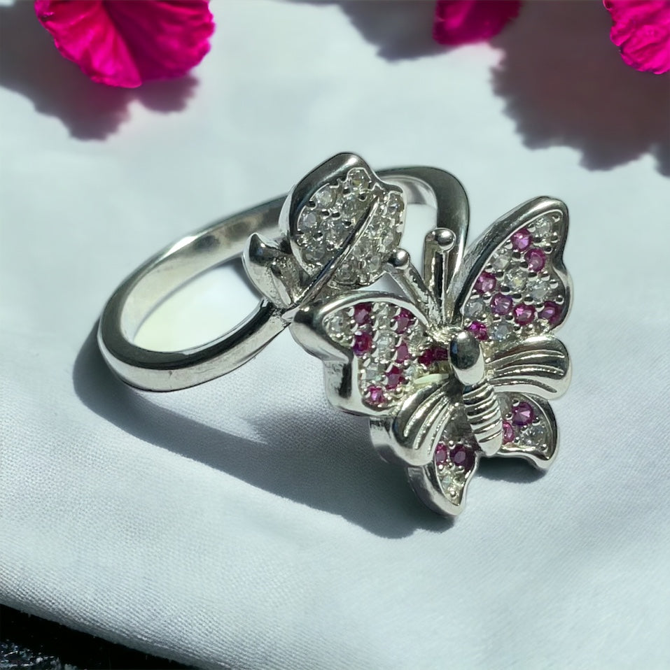 a close up of a ring with a butterfly on it