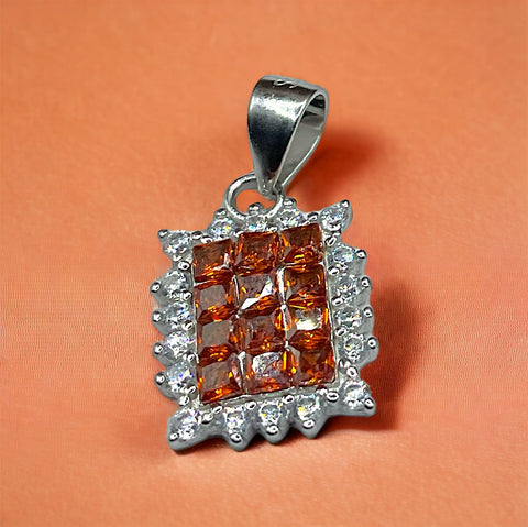 a pendant with a square shaped orange stone surrounded by white diamonds