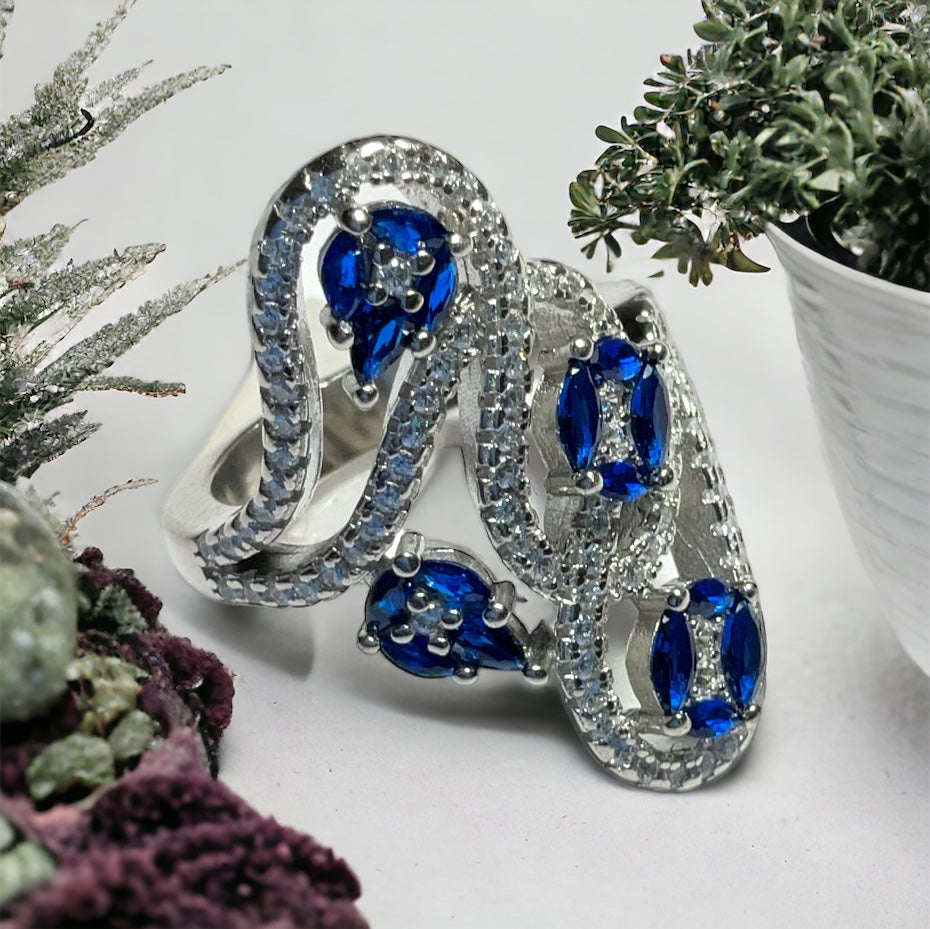 a close up of a ring on a table next to a potted plant