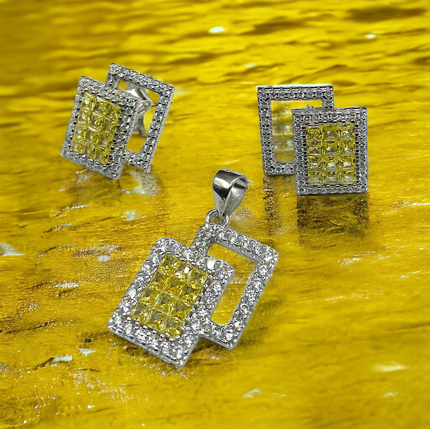 a pair of yellow and white diamond earrings