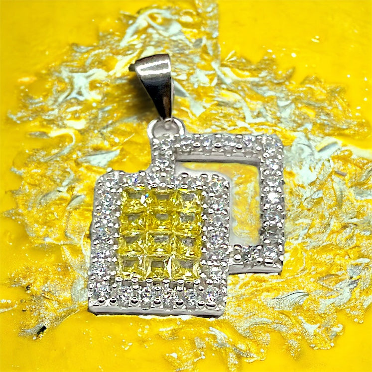 a yellow and white diamond pendant on a yellow background