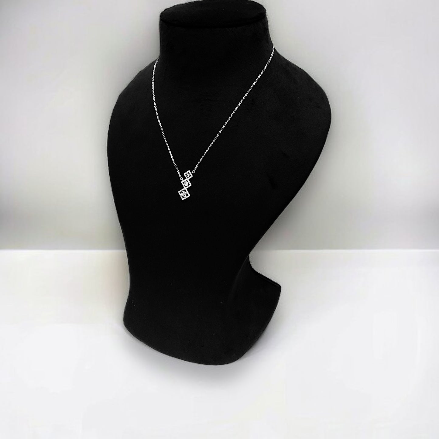 a black mannequin with a necklace on it