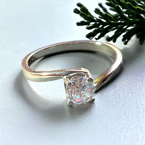 a close up of a ring with a tree in the background