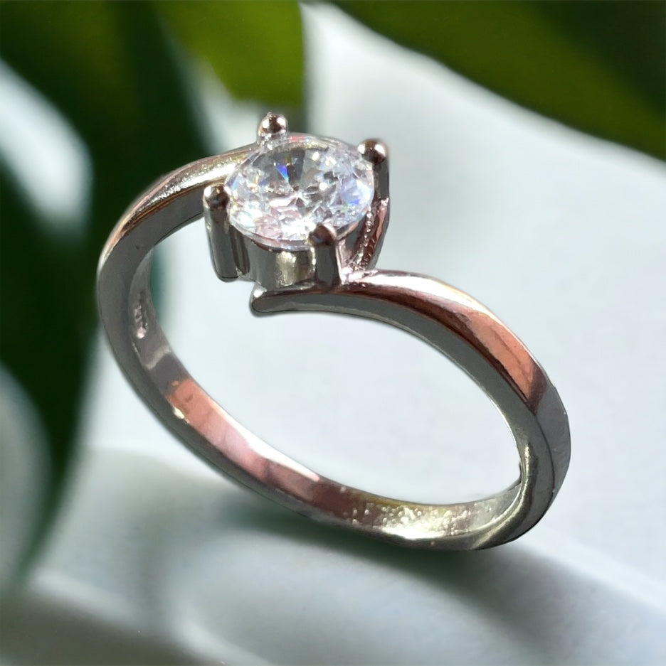 a close up of a diamond ring on a table